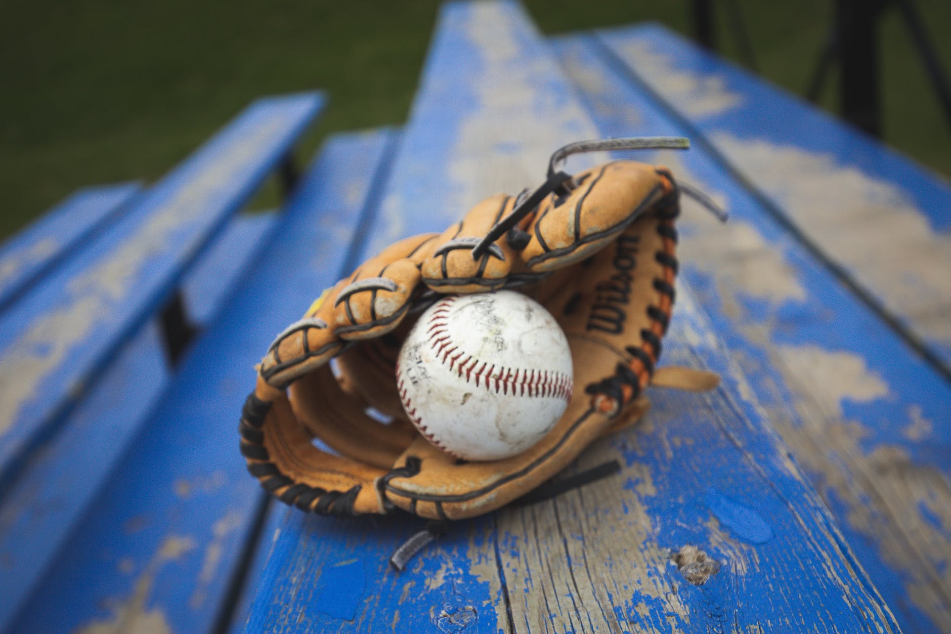 close up shot of baseball and baseball glove