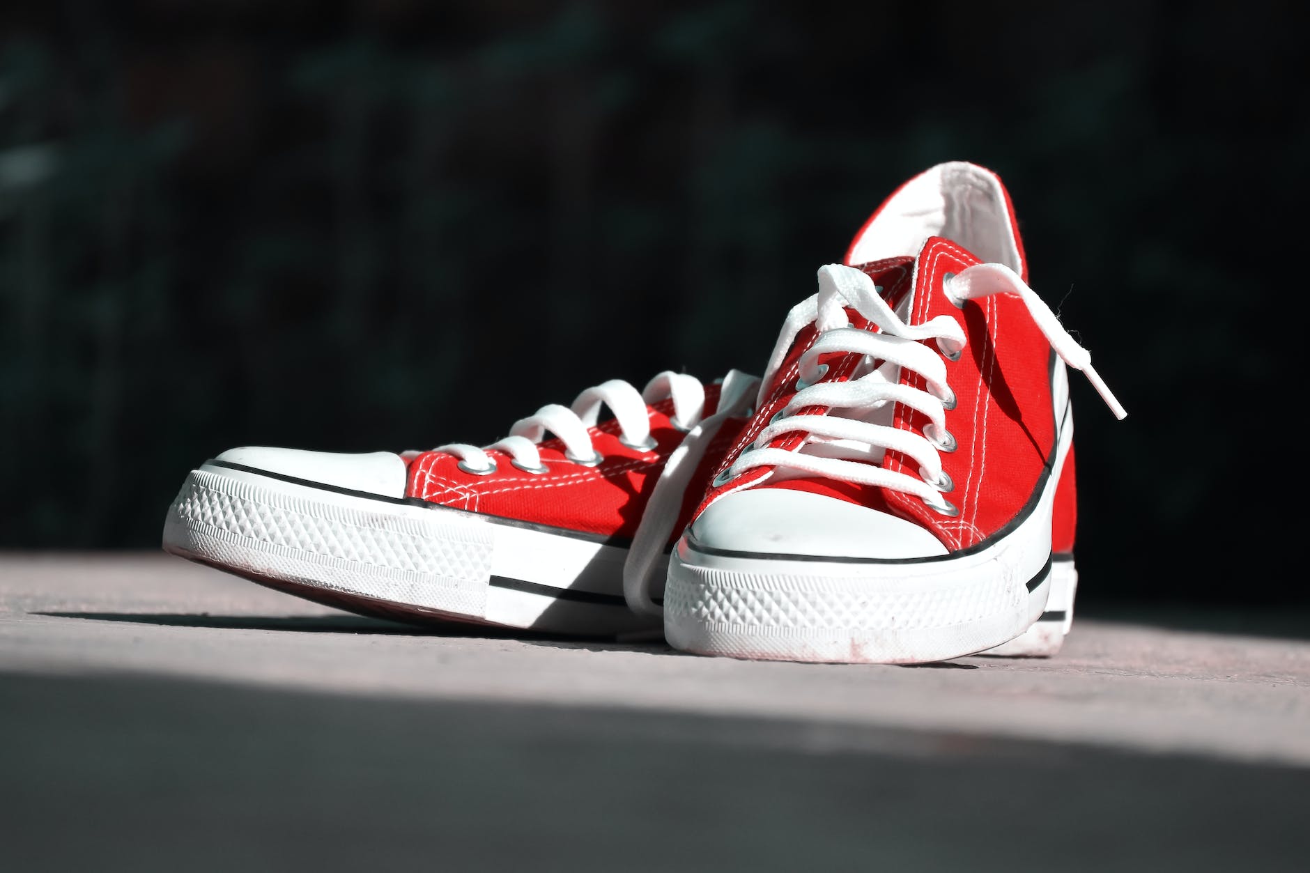 shallow focus photography of pair of red low top sneakers