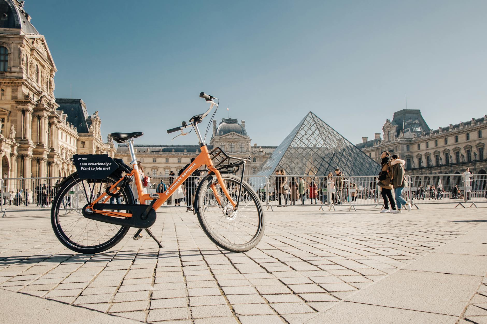 a rental bicycle standing on the background of the louvre in paris france