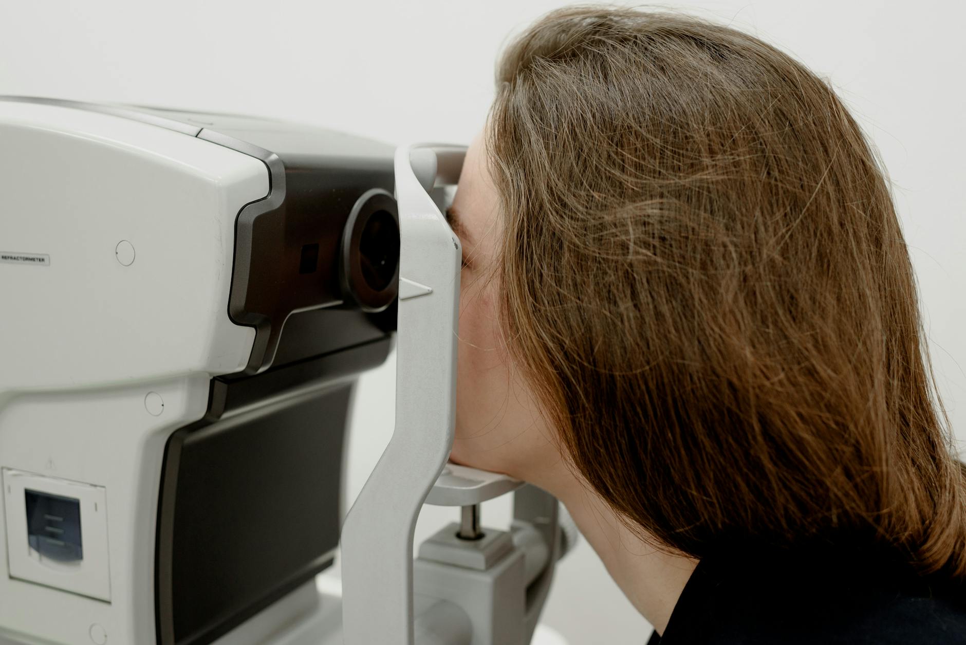 woman checking eyesight on modern equipment