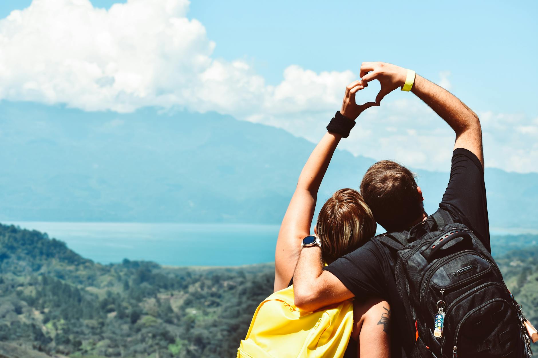 two people forming heart hand shape