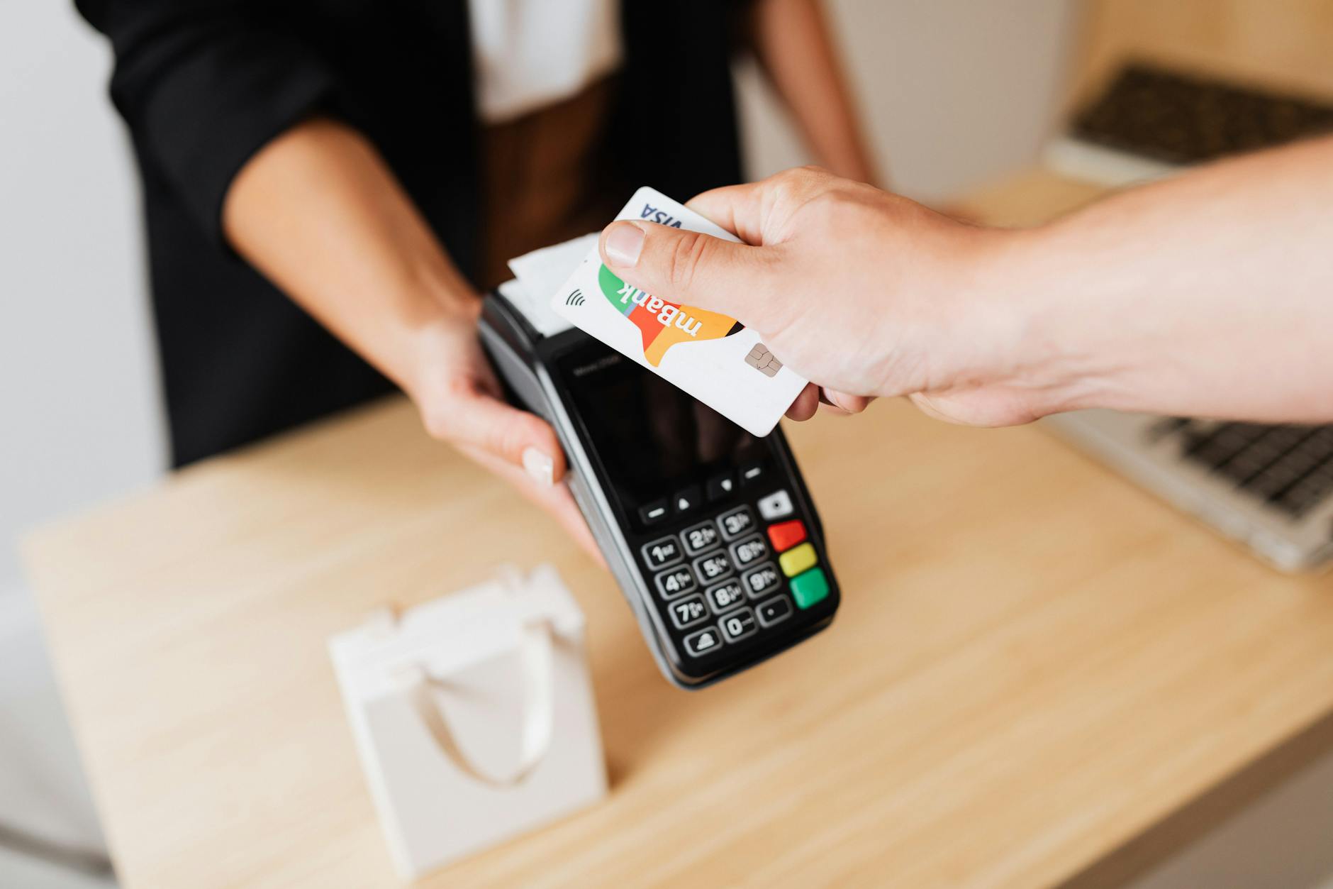 a person making a cashless shop transaction